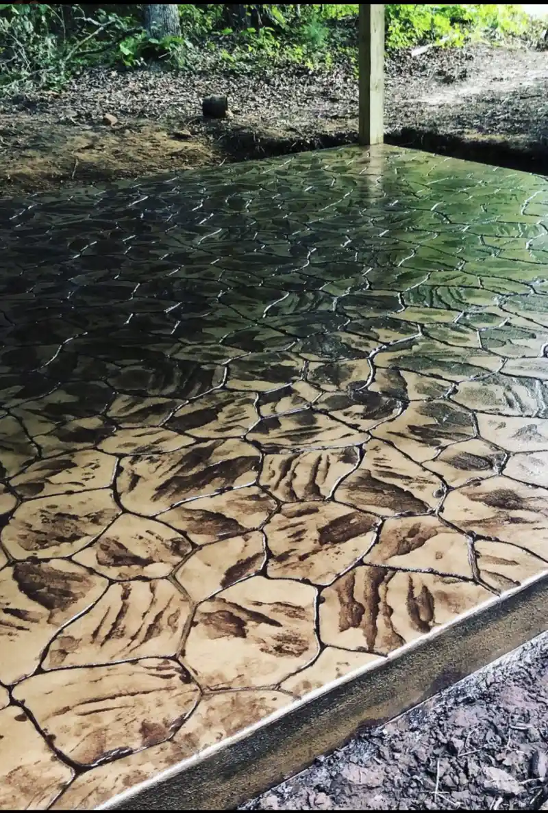 A large stamped concrete area in an irregular flagstone pattern, coloured in tan and brown tones.
