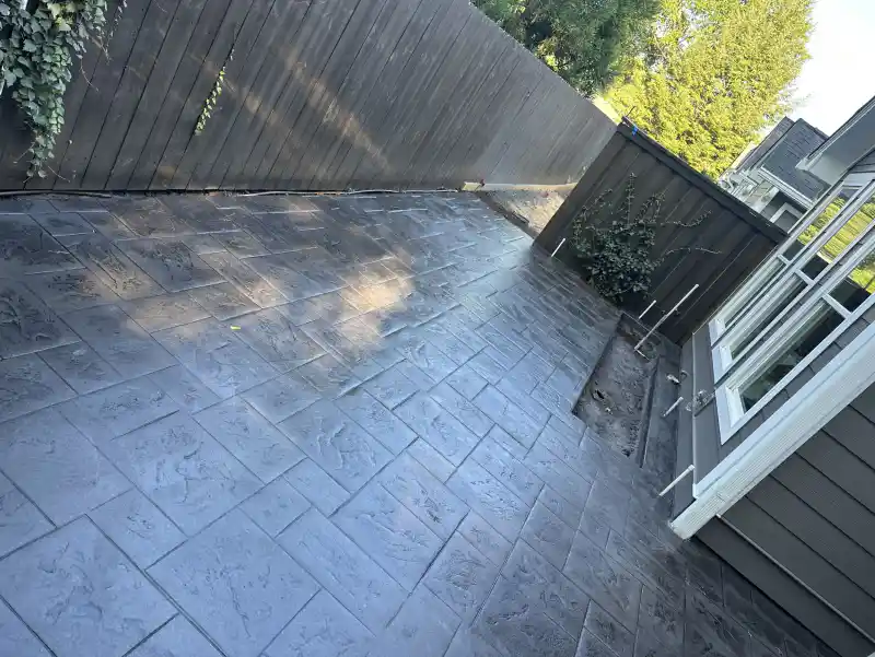 A stamped concrete walkway running alongside a building.